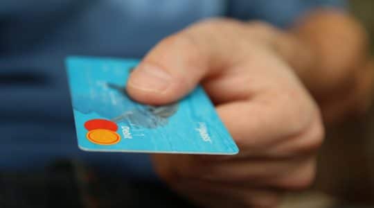 Man holding a credit card in the new era of retail.