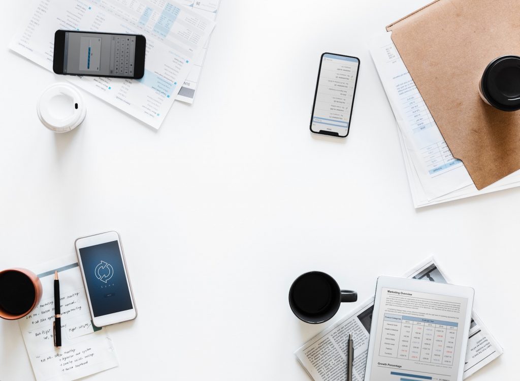 Business items laying on white background